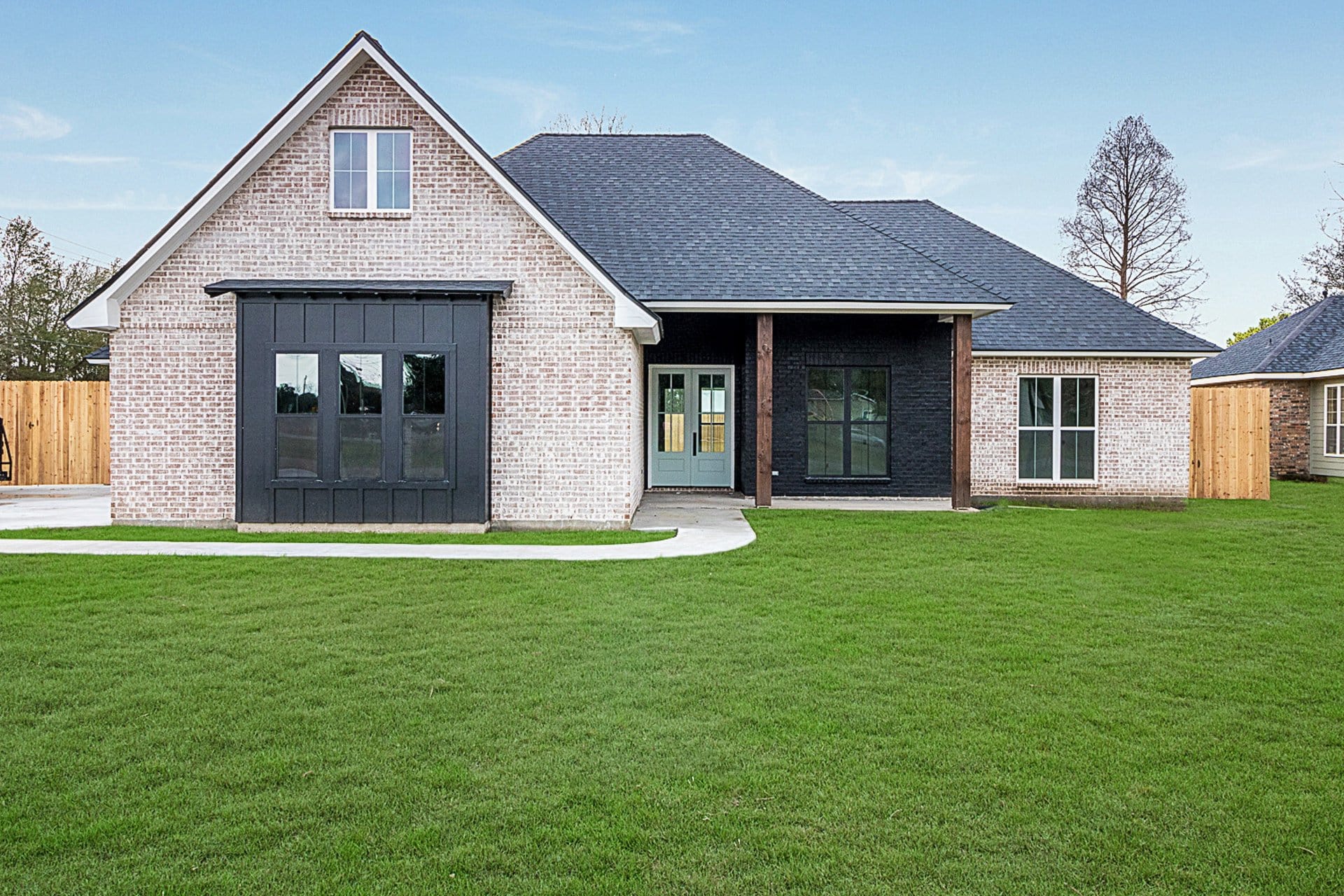 A brick home with a grassy yard.